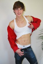 Guy with longish hair flashing his amazing abs on camera