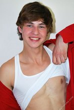 Guy with longish hair flashing his amazing abs on camera