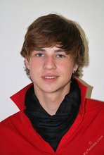 Long-haired twink in red slowly undressing in front of the cam