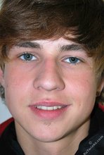 Long-haired twink in red slowly undressing in front of the cam
