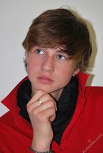 Long-haired twink in red slowly undressing in front of the cam