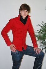Long-haired twink in red slowly undressing in front of the cam