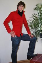 Long-haired twink in red slowly undressing in front of the cam