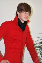 Long-haired twink in red slowly undressing in front of the cam