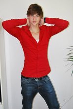 Long-haired twink in red slowly undressing in front of the cam
