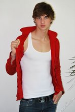 Long-haired twink in red slowly undressing in front of the cam