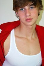 Long-haired twink in red slowly undressing in front of the cam