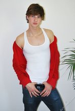 Long-haired twink in red slowly undressing in front of the cam