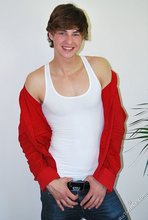 Long-haired twink in red slowly undressing in front of the cam