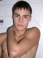 Slim twink showing his amazing body while posing by the wall