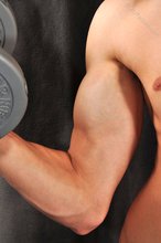 Good-looking guy lifting weights and looking sexy as fuck