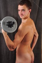 Good-looking guy lifting weights and looking sexy as fuck