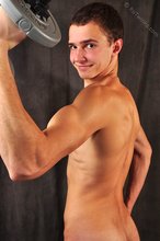 Good-looking guy lifting weights and looking sexy as fuck
