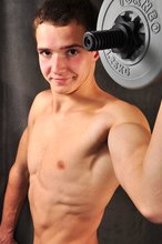 Good-looking guy lifting weights and looking sexy as fuck