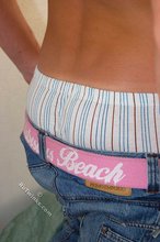 Tanned guy with a hot body showing his muscular back as well