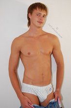 Tanned guy with a hot body showing his muscular back as well