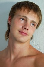 Tanned guy with a hot body showing his muscular back as well