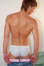Tanned guy with a hot body showing his muscular back as well