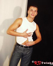 Good-looking guy with a girly-looking face shows his abs