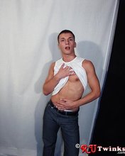 Good-looking guy with a girly-looking face shows his abs