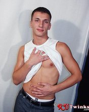 Good-looking guy with a girly-looking face shows his abs