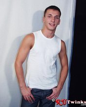 Good-looking guy with a girly-looking face shows his abs