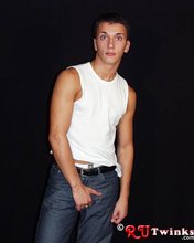 Good-looking guy with a girly-looking face shows his abs