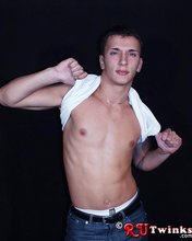 Good-looking guy with a girly-looking face shows his abs