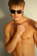 Naked guy puts on his shades to strike a few very sexy poses
