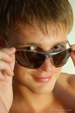 Naked guy puts on his shades to strike a few very sexy poses