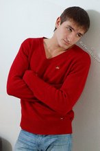 Dark-haired guy dressed in red teases his nips thru the sweater