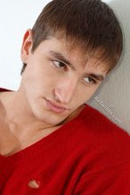 Dark-haired guy dressed in red teases his nips thru the sweater