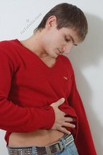 Dark-haired guy dressed in red teases his nips thru the sweater