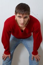 Dark-haired guy dressed in red teases his nips thru the sweater