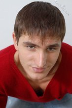 Dark-haired guy dressed in red teases his nips thru the sweater