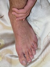 Dark-haired dude showing his sexy soles and his tight ass
