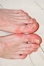 Dark-haired guy shows off his cock and sexy feet on camera