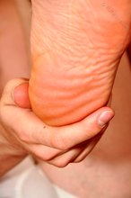 Dark-haired guy shows off his cock and sexy feet on camera