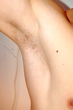 Blond-haired guy posing next to a lamp after fucking the wall