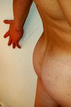 Blond-haired guy posing next to a lamp after fucking the wall