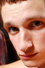 Naughty twink with a sad look in his face posing on all fours