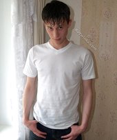 Sweaty/greasy-looking twink undressing next to a window