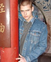 Denim-loving guy posing outdoors, looking mean/lean