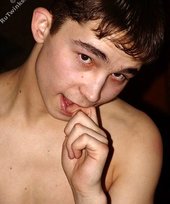 Brown-eyed twink posing half-naked and touching himself