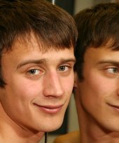 Blue-eyed twink showing his half-naked body