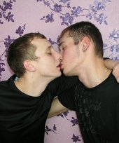 Dark-haired twinks passionately making out by the wall