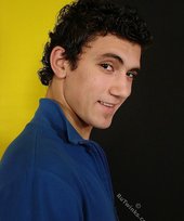 Curly-haired twink seducing with his six-pack