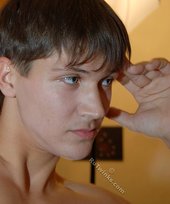 Jacked-up twink showing his ass in front of a camera