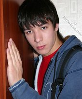 Long-haired brunette boy mean-mugging the camera