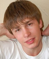 Blond-haired boy takes his shirt off and looks sexy